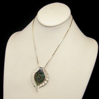 pendant necklace that features a large leaf shaped glass pendant