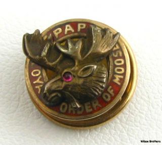 This vintage pin features a red enameled border reading PAP Loyal