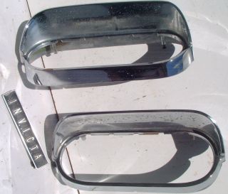 This is an original pair of taillight bezels for a 1961 Buick.
